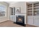 Living room displaying fireplace with modern mantel and adjacent built-in shelving at 531 Headwind Way, Alpharetta, GA 30005