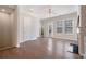 Open-concept living room with white trim, hardwood floors, and plenty of natural light at 531 Headwind Way, Alpharetta, GA 30005