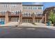 Exterior shot of townhomes with garages and a communal parking, on a sunny day at 531 Headwind Way, Alpharetta, GA 30005
