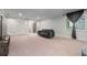 Large basement area with carpet, TV, and sofa provides flexible space for entertaining or relaxing at 145 Mount Shasta Ln, Johns Creek, GA 30022
