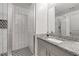 Updated bathroom features modern vanity, tile shower with glass door, and decorative floor tiles at 145 Mount Shasta Ln, Johns Creek, GA 30022