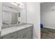 Bathroom with gray vanity, granite countertop, large mirror and doorway to exercise room at 145 Mount Shasta Ln, Johns Creek, GA 30022