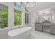 Bright bathroom featuring a standalone tub, walk-in shower, and granite counters at 145 Mount Shasta Ln, Johns Creek, GA 30022