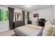 Well-lit bedroom with large windows, neutral colors, closet, and desk, offering a relaxing atmosphere at 145 Mount Shasta Ln, Johns Creek, GA 30022
