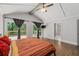 Bright bedroom featuring hardwood floors, vaulted ceiling, and access to a private deck at 145 Mount Shasta Ln, Johns Creek, GA 30022