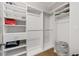 Walk-in closet features custom shelving and plenty of storage space at 145 Mount Shasta Ln, Johns Creek, GA 30022