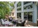 Spacious wooden deck with outdoor seating, lots of windows, and lush landscaping at 145 Mount Shasta Ln, Johns Creek, GA 30022