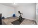 Exercise room with wood-look tile floors, exercise bike, weights, and ball at 145 Mount Shasta Ln, Johns Creek, GA 30022