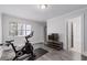 Exercise room with exercise bike, TV, view to bathroom and window at 145 Mount Shasta Ln, Johns Creek, GA 30022