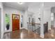 Foyer features hardwood flooring and a staircase with decorative railings at 145 Mount Shasta Ln, Johns Creek, GA 30022