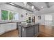 Modern kitchen with stainless steel appliances, granite countertops, gray island, and hardwood floors at 145 Mount Shasta Ln, Johns Creek, GA 30022
