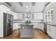 Beautiful kitchen featuring stainless steel appliances, granite countertops and a gray kitchen island at 145 Mount Shasta Ln, Johns Creek, GA 30022