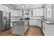 Modern kitchen featuring stainless steel appliances, white cabinets, granite countertops and a gray kitchen island at 145 Mount Shasta Ln, Johns Creek, GA 30022