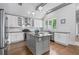 Bright kitchen featuring stainless steel appliances, white cabinets, granite countertops and hardwood floors at 145 Mount Shasta Ln, Johns Creek, GA 30022