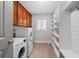 Spacious laundry room with washer, dryer, storage cabinets, and shelving units at 145 Mount Shasta Ln, Johns Creek, GA 30022