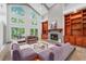 Cozy living room with a fireplace, built-in cabinets, and views of the outdoors at 145 Mount Shasta Ln, Johns Creek, GA 30022