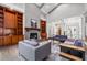 Inviting living room with fireplace, built-in shelving, neutral paint, hardwood floors and lots of natural light at 145 Mount Shasta Ln, Johns Creek, GA 30022