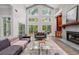 Open concept living room with floor to ceiling windows and modern furnishings at 145 Mount Shasta Ln, Johns Creek, GA 30022
