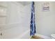 A clean bathroom features a white shower and tub combination with decorative blue shower curtain at 24317 Plantation Ne Dr # 317, Atlanta, GA 30324