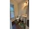Cozy powder room featuring pedestal sink, toilet, and window for natural light at 3235 Chutney Ct, Avondale Estates, GA 30002