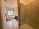 Tiled bathroom featuring walk-in glass shower, soaking tub, and double vanity at 3235 Chutney Ct, Avondale Estates, GA 30002