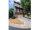 Beautiful townhome featuring a charming balcony, stone accents, and a well-maintained lawn on a sunny day at 3235 Chutney Ct, Avondale Estates, GA 30002