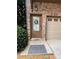 Inviting front door with stone accents, a decorative wreath, and a 'Welcome' mat near the garage at 3235 Chutney Ct, Avondale Estates, GA 30002