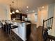 Modern kitchen featuring a breakfast bar with stools, stainless steel appliances, and dark wood floors at 3235 Chutney Ct, Avondale Estates, GA 30002