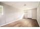 Finished basement featuring hardwood floors, a white door to the outside, and a brick accent wall at 4009 Kirksford Dr, Decatur, GA 30035