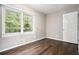Cozy bedroom with hardwood floors, neutral paint, and a large window overlooking the yard at 4009 Kirksford Dr, Decatur, GA 30035