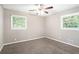Bedroom featuring neutral walls, carpet, ceiling fan, and two windows with natural light at 4009 Kirksford Dr, Decatur, GA 30035