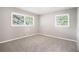 Bedroom with neutral walls, carpet, and natural light from two windows with white blinds at 4009 Kirksford Dr, Decatur, GA 30035