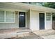 Close-up of the front porch featuring two doors with brick and wood elements at 4009 Kirksford Dr, Decatur, GA 30035