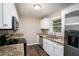 Modern kitchen featuring stainless steel appliances, white cabinets, and granite countertops at 4009 Kirksford Dr, Decatur, GA 30035