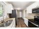 Well-lit kitchen featuring stainless steel appliances, granite countertops, and a sink with modern fixtures at 4009 Kirksford Dr, Decatur, GA 30035
