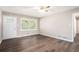 Bright living room with hardwood floors, a ceiling fan, a window, and a white door at 4009 Kirksford Dr, Decatur, GA 30035