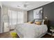 Comfortable bedroom featuring a large bed, stylish rug, and dark accent wall at 4113 Ashford Green Dr, Duluth, GA 30096