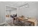 Modern dining room featuring stylish lighting, contemporary furniture, and a view into the living area at 4113 Ashford Green Dr, Duluth, GA 30096