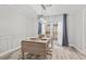 Charming dining area featuring a table set for four, wood flooring and modern lighting fixture at 4113 Ashford Green Dr, Duluth, GA 30096