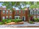 Charming brick townhome with manicured landscaping, providing a welcoming and picturesque curb appeal at 4113 Ashford Green Dr, Duluth, GA 30096