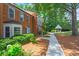 Serene community featuring brick townhomes, lush greenery, and a charming gazebo, creating a tranquil atmosphere at 4113 Ashford Green Dr, Duluth, GA 30096
