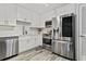 Modern kitchen featuring stainless steel appliances, white cabinets, and wood-look tile flooring at 4113 Ashford Green Dr, Duluth, GA 30096