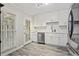 Bright kitchen featuring white cabinets, modern appliances, and light tile backsplash at 4113 Ashford Green Dr, Duluth, GA 30096