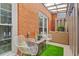 Comfortable outdoor patio featuring chairs, storage, privacy fence and faux turf at 4113 Ashford Green Dr, Duluth, GA 30096