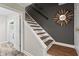 Elegant staircase featuring wood and white accents, leading to the upper level with modern design elements at 4113 Ashford Green Dr, Duluth, GA 30096