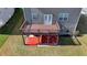 Aerial view of deck with railings over a red brick landing in a grassy backyard with dark mulch bed at 4250 Pembia Dr, Cumming, GA 30028