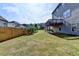 Large grassy backyard with a wooden fence and a view of the home's rear deck at 4250 Pembia Dr, Cumming, GA 30028