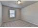 This bedroom has neutral walls and carpet and one window for natural light at 4250 Pembia Dr, Cumming, GA 30028