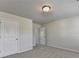 This bedroom features carpet, neutral walls and two doors for closet and hallway access at 4250 Pembia Dr, Cumming, GA 30028
