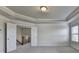 A spacious bedroom with an attached stairway and neutral colored walls at 4250 Pembia Dr, Cumming, GA 30028